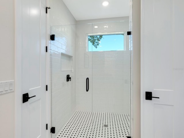 bathroom featuring a shower with door