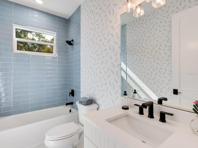 full bathroom with tiled shower / bath combo, toilet, and vanity