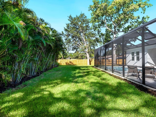 view of yard with a lanai and a patio