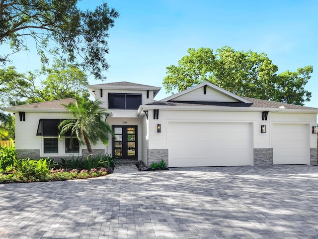 view of front of property featuring french doors and a garage