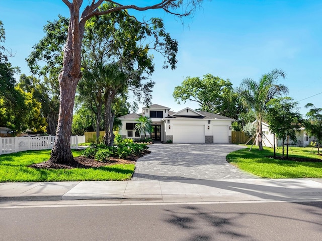 view of front of home featuring a front lawn and a garage