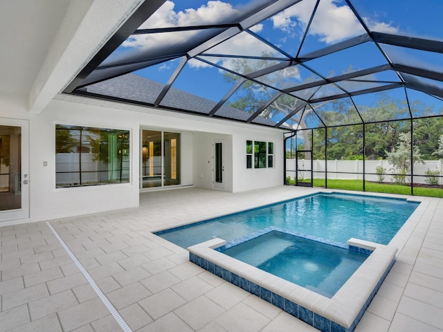 view of swimming pool with an in ground hot tub, a lanai, and a patio