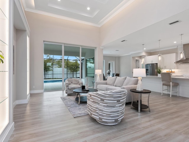 living room featuring a high ceiling and crown molding