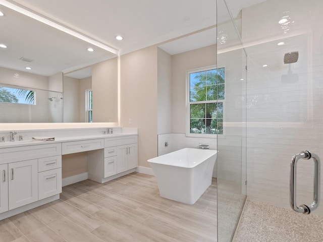 bathroom with separate shower and tub and vanity