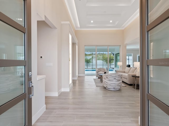 entryway featuring a high ceiling and ornamental molding