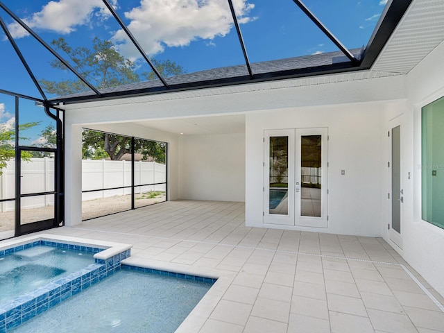 view of pool featuring french doors, glass enclosure, an in ground hot tub, and a patio