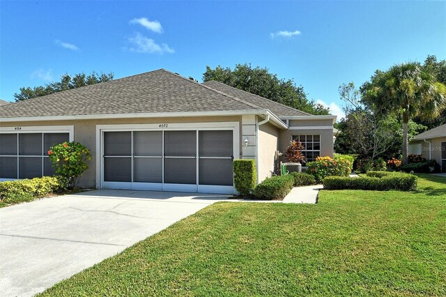 ranch-style house featuring a front yard and a garage