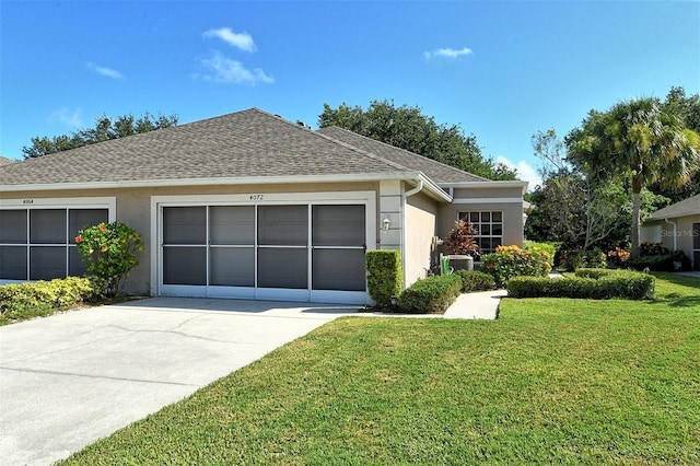 ranch-style home with an attached garage, concrete driveway, roof with shingles, stucco siding, and a front yard