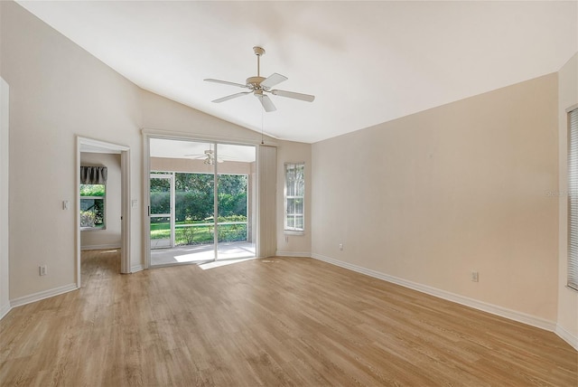 unfurnished room with light wood-style floors, vaulted ceiling, baseboards, and a ceiling fan