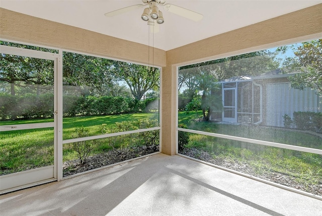 unfurnished sunroom with a healthy amount of sunlight and a ceiling fan