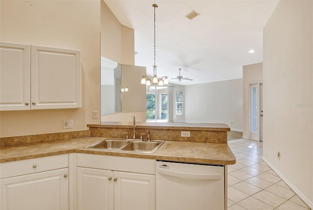 kitchen featuring pendant lighting, light countertops, white dishwasher, a sink, and a peninsula