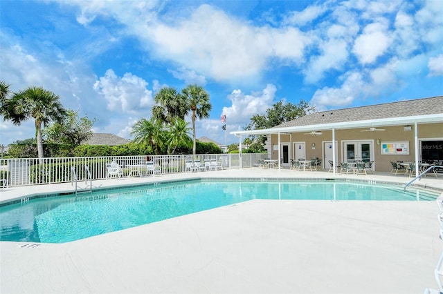 pool featuring a ceiling fan, french doors, fence, and a patio