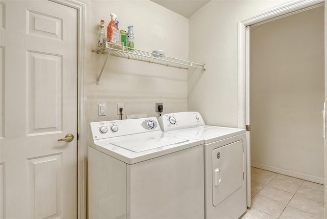 laundry area with laundry area, baseboards, separate washer and dryer, and light tile patterned flooring