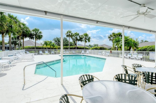 pool featuring a patio area, fence, and a ceiling fan