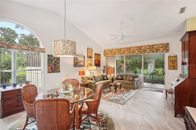 dining space featuring ceiling fan, high vaulted ceiling, visible vents, and a wealth of natural light