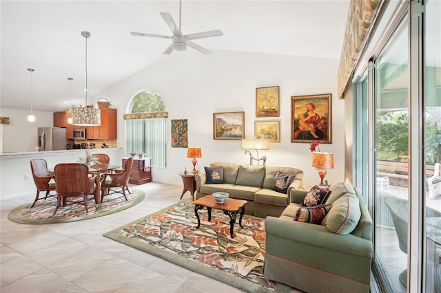 living area with ceiling fan and high vaulted ceiling