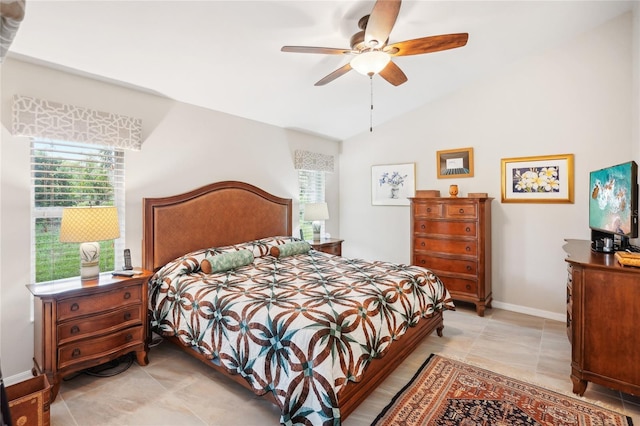 bedroom featuring lofted ceiling, baseboards, and a ceiling fan