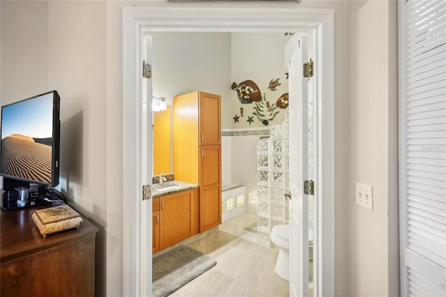 full bath with tile patterned floors, vanity, toilet, and a walk in shower