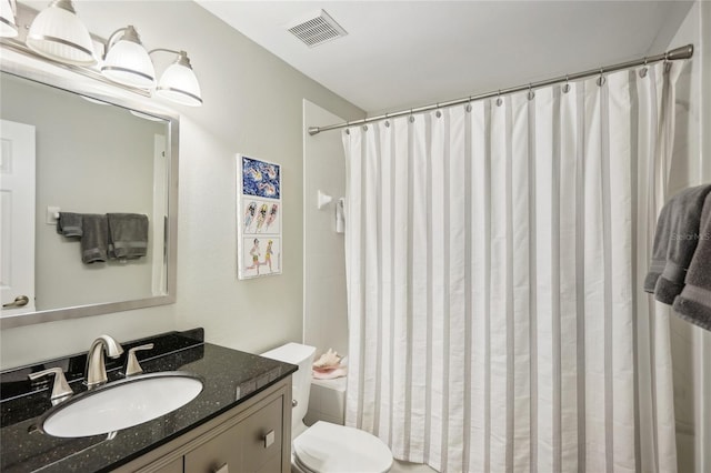 bathroom featuring a shower with curtain, visible vents, vanity, and toilet