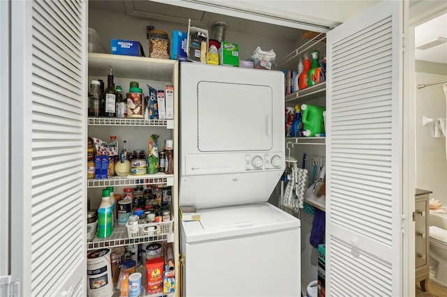 washroom featuring laundry area, stacked washer / dryer, and visible vents