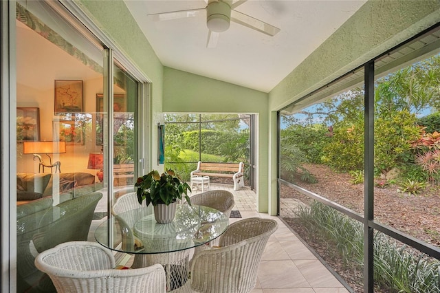 sunroom / solarium with lofted ceiling and a ceiling fan