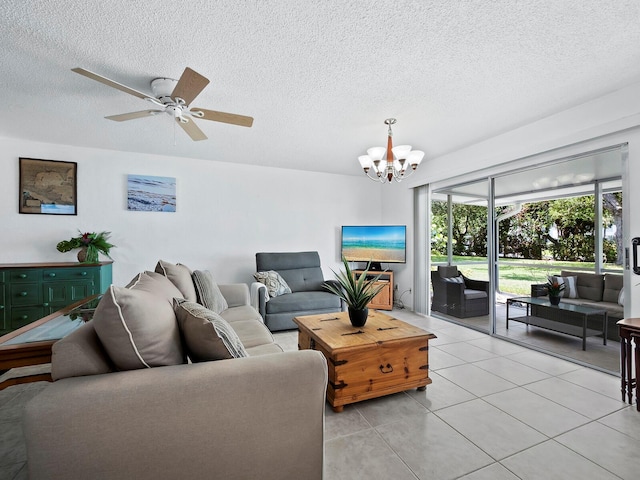 living room with a textured ceiling, light tile patterned floors, and ceiling fan with notable chandelier