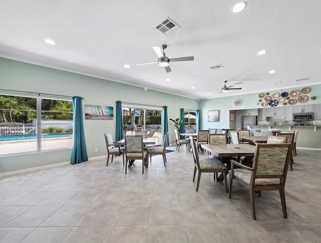 dining room featuring crown molding, a healthy amount of sunlight, and ceiling fan