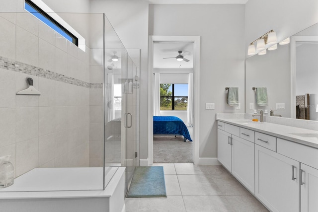 bathroom with ceiling fan, a shower with shower door, vanity, and tile patterned flooring