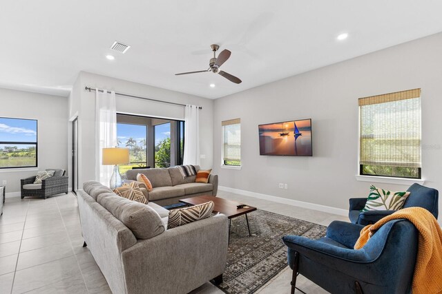 living room with ceiling fan and light tile patterned floors