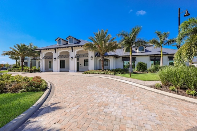 mediterranean / spanish house featuring a front yard