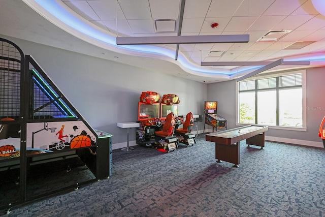 rec room with a tray ceiling and carpet flooring