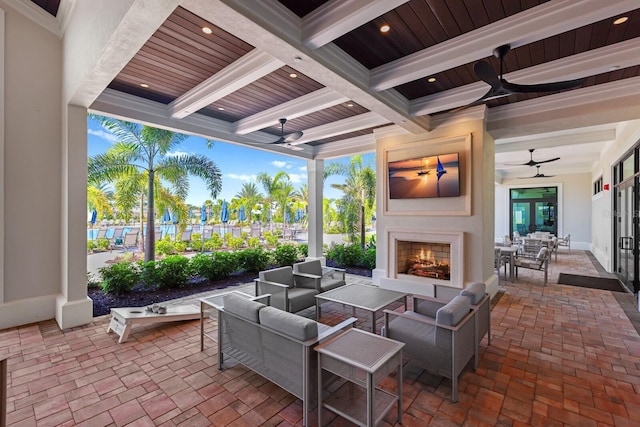 view of patio / terrace with an outdoor living space with a fireplace