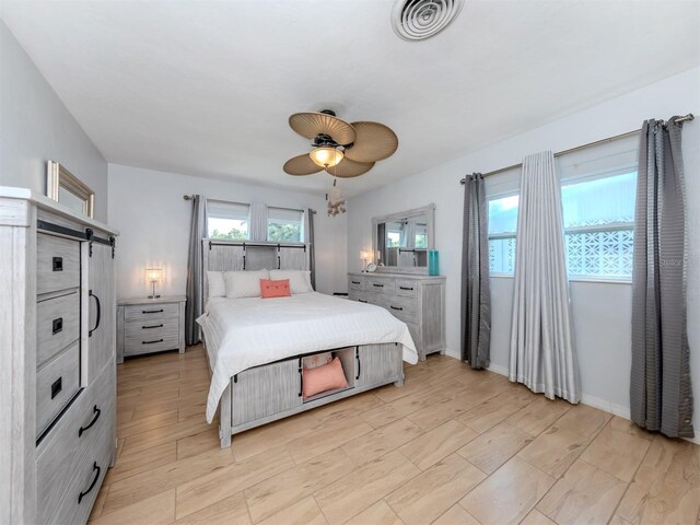 bedroom featuring multiple windows and ceiling fan