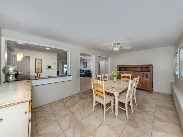 dining area with light tile patterned flooring and ceiling fan