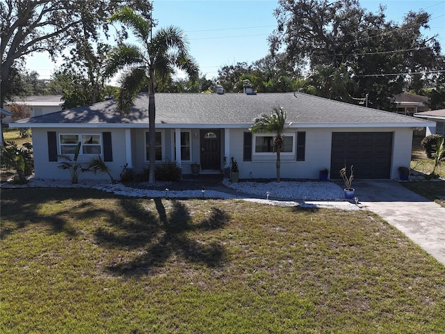 ranch-style house featuring a garage and a front lawn