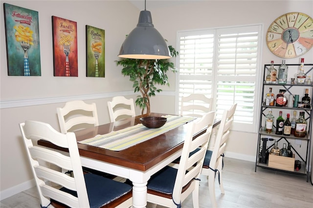 dining room with wood finished floors and baseboards