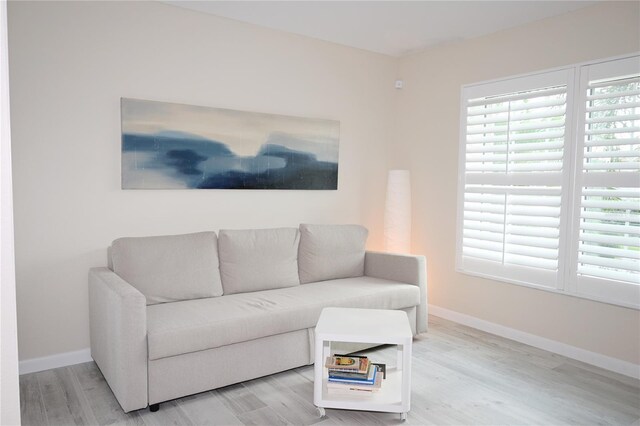 living room with light wood-style flooring and baseboards