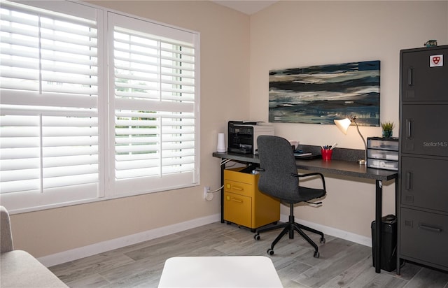 office featuring light wood-style flooring and baseboards