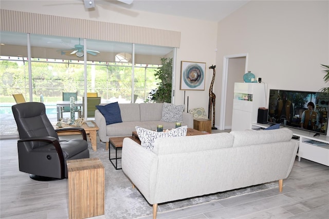 living room with ceiling fan and light wood-type flooring