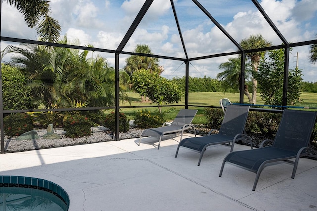 view of patio featuring glass enclosure