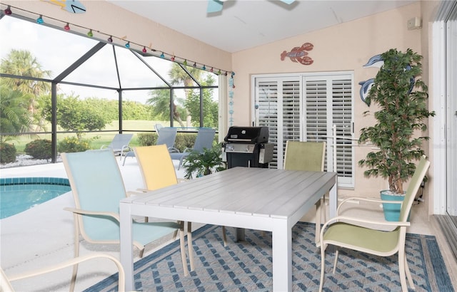 view of patio with a grill and glass enclosure