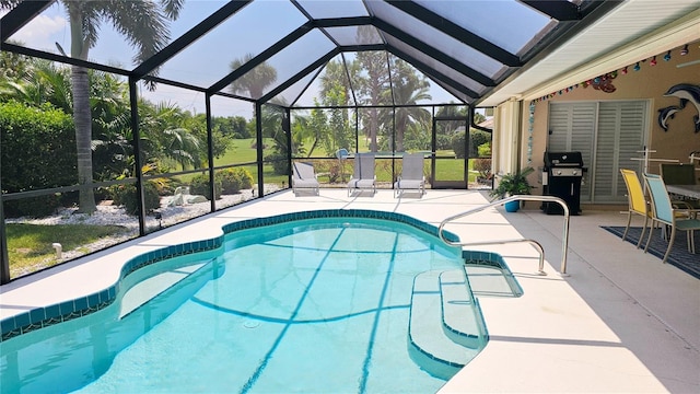 view of swimming pool with area for grilling, a lanai, and a patio area