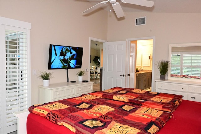 bedroom with lofted ceiling, ceiling fan, and ensuite bath