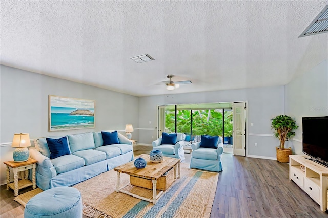 living room featuring a textured ceiling, ceiling fan, and hardwood / wood-style floors