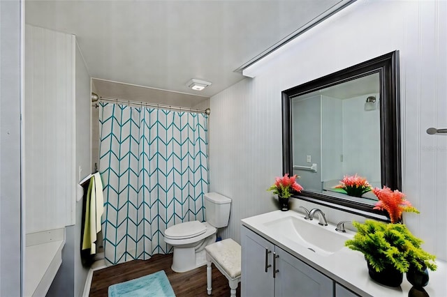 bathroom featuring toilet, hardwood / wood-style flooring, and vanity