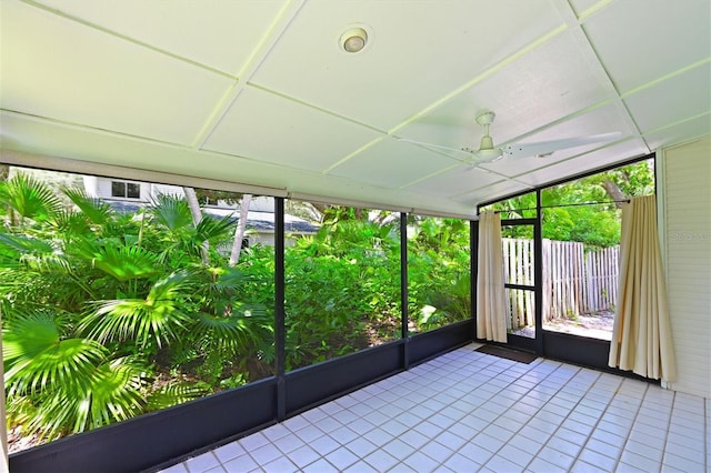 unfurnished sunroom with ceiling fan