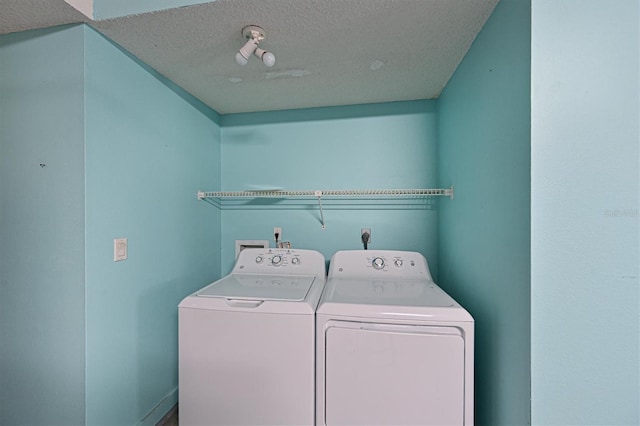 washroom featuring separate washer and dryer and a textured ceiling