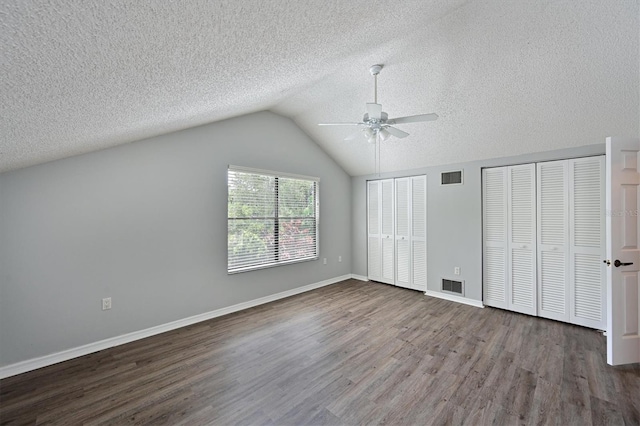 additional living space with ceiling fan, vaulted ceiling, a textured ceiling, and wood-type flooring