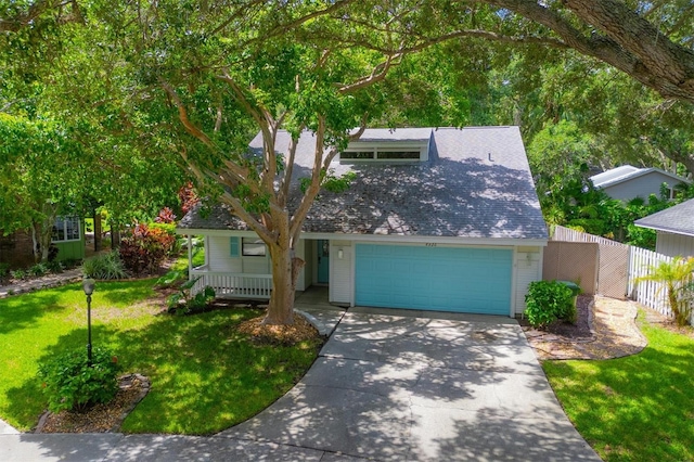 view of front of home with a garage and a front lawn