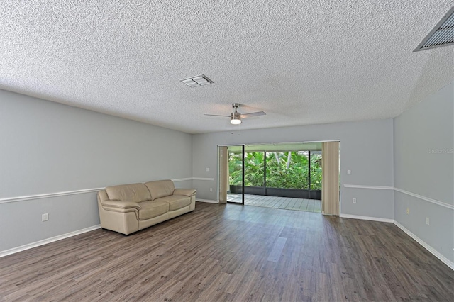 unfurnished living room with ceiling fan, hardwood / wood-style flooring, and a textured ceiling